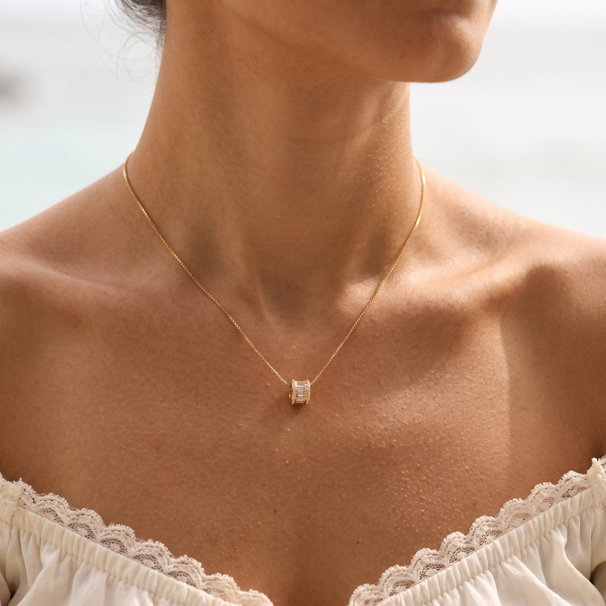Wider view of a woman wearing the Baguette Slider Necklace