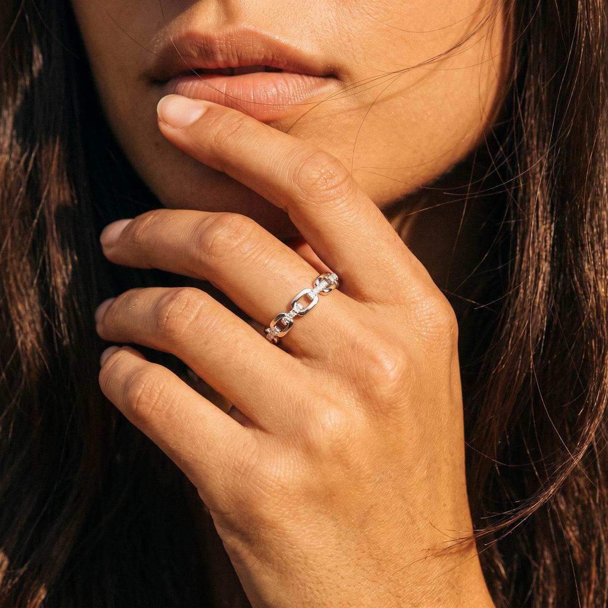 Wider view of a hand wearing the Cable Link Ring