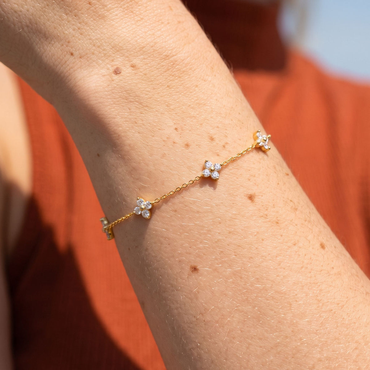 Clover Chain Bracelet worn on the wrist, photographed in natural daylight.