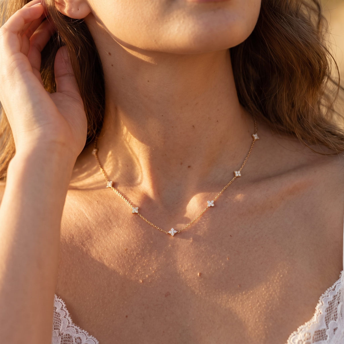 Wider view of a woman wearing the Clover Cluster Necklace