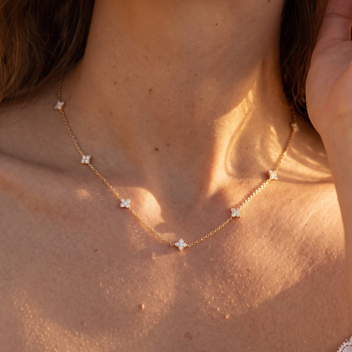 Close-up of the Clover Cluster Necklace worn on the neckline