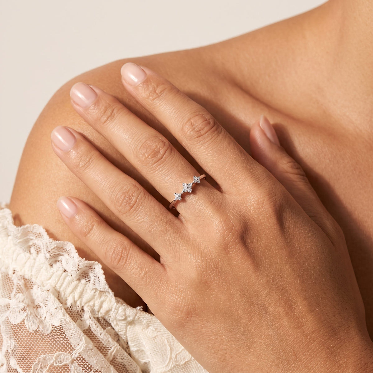 Wider view of a hand wearing the Clover Trio Ring