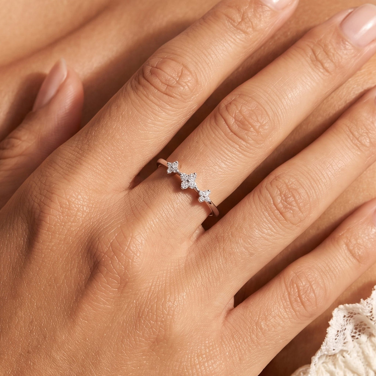 Close-up of the Clover Trio Ring worn on the finger