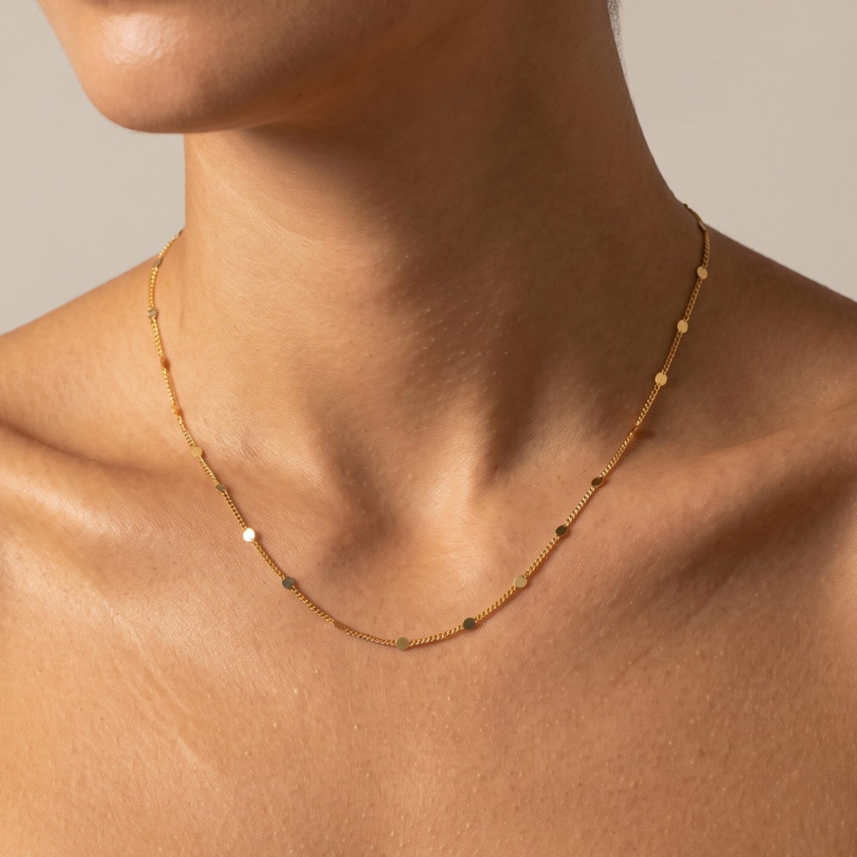 Close-up of the Confetti Necklace worn on the neckline