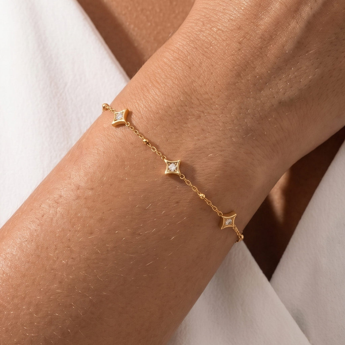 Close-up of the Constellation Bracelet on the wrist featuring star-shaped crystal charms