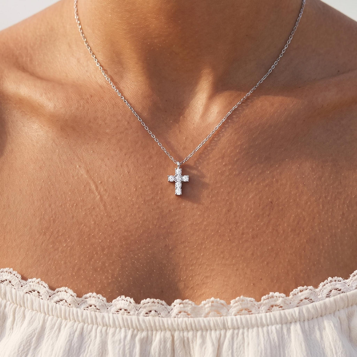 Close-up of the Crystal Cross Pendant worn on the neckline