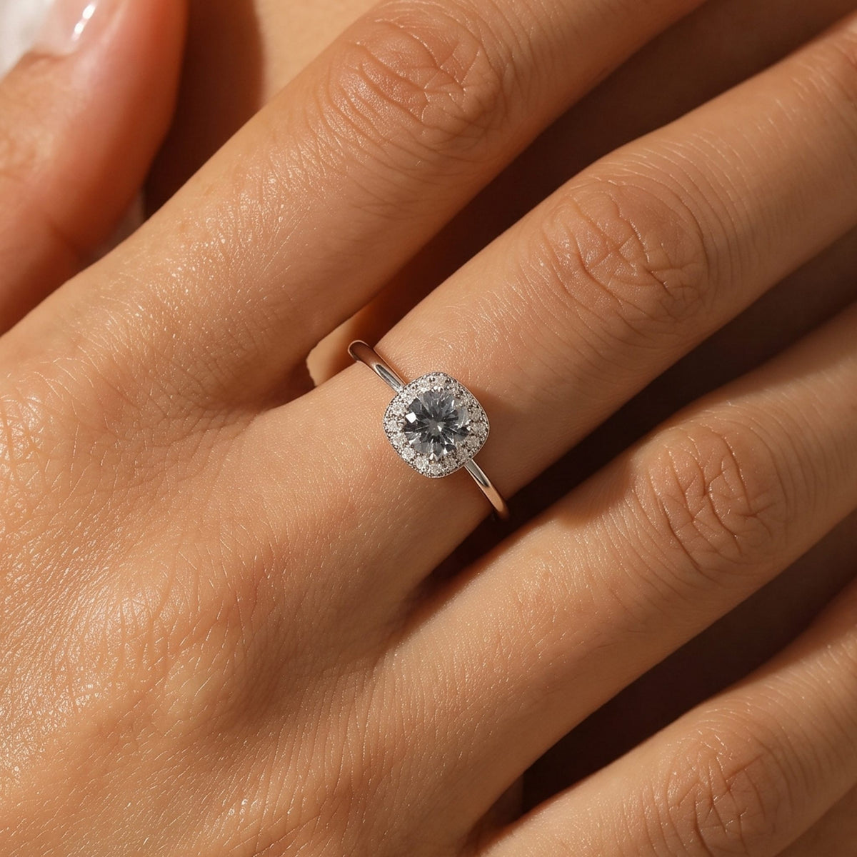Close-up of the Cushion Halo Ring worn on the finger