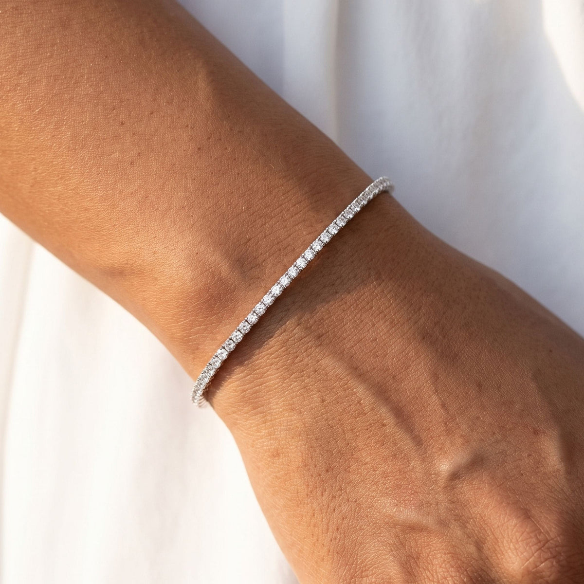 Dainty Tennis Bracelet worn on the wrist, photographed in natural daylight.