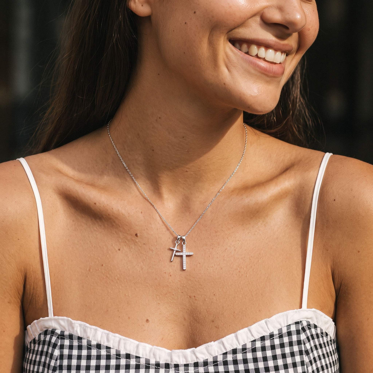 Wider view of a woman wearing the Double Cross Necklace