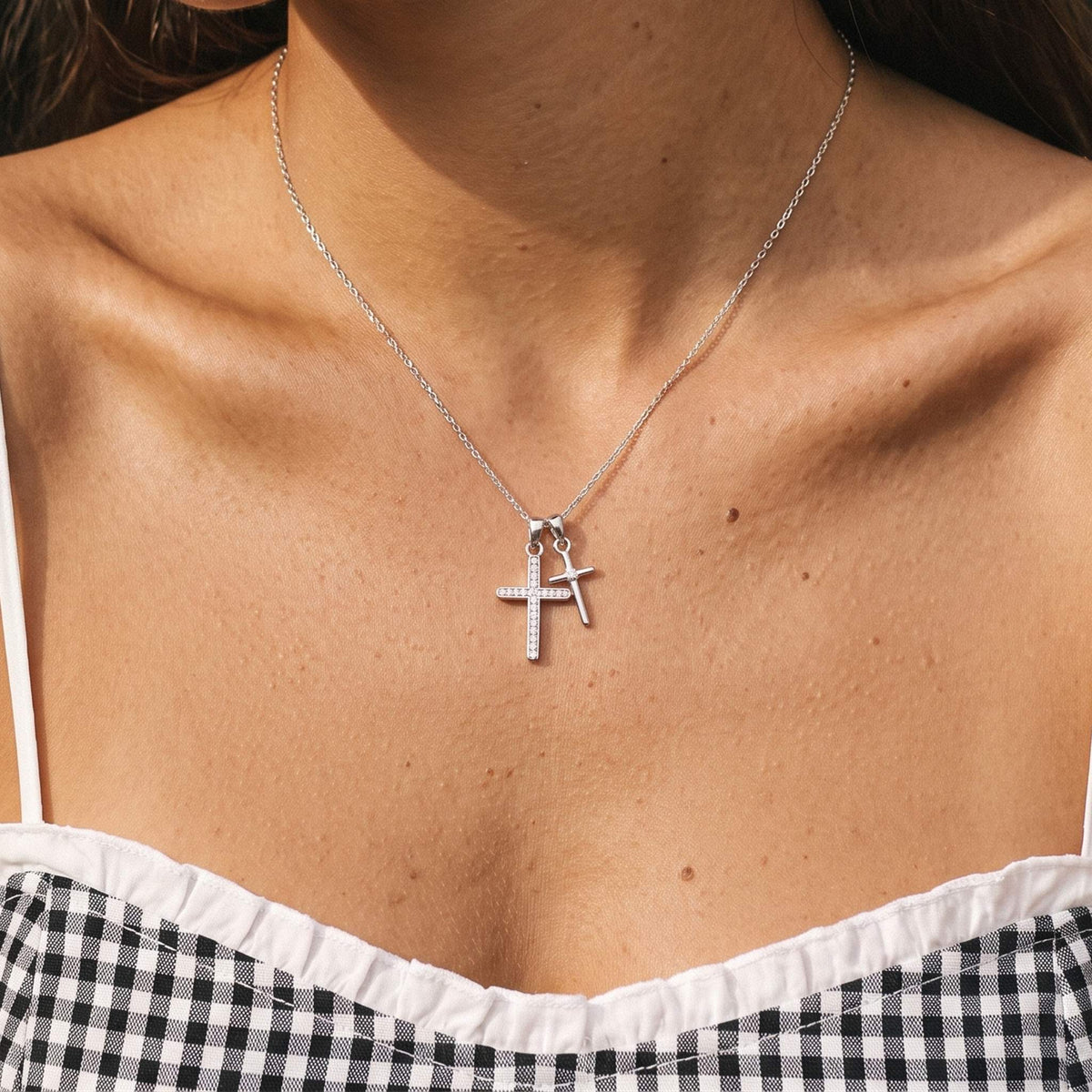 Close-up of the Double Cross Necklace worn on the neckline