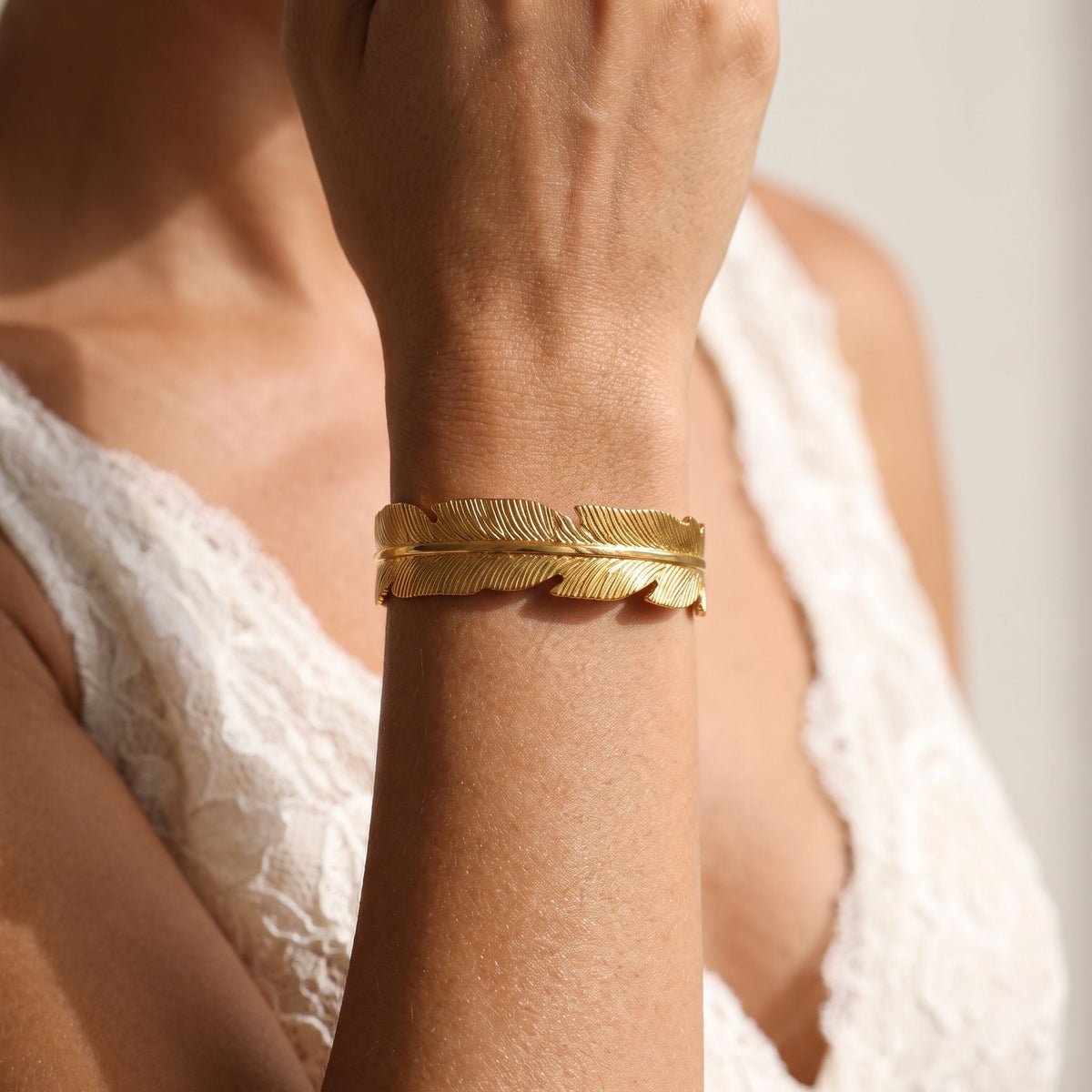 Feather Cuff worn on the wrist, showing the open ends of the cuff.