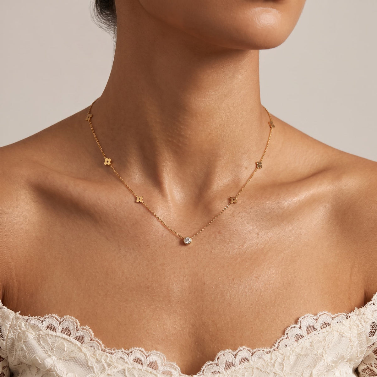 Wider view of a woman wearing the Flat Clover Necklace