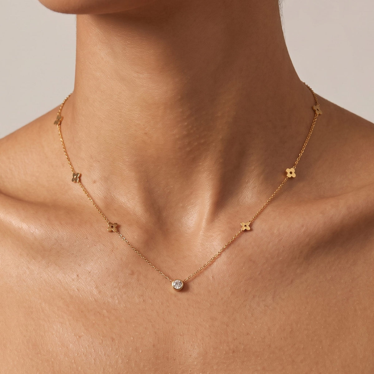 Close-up of the Flat Clover Necklace worn on the neckline