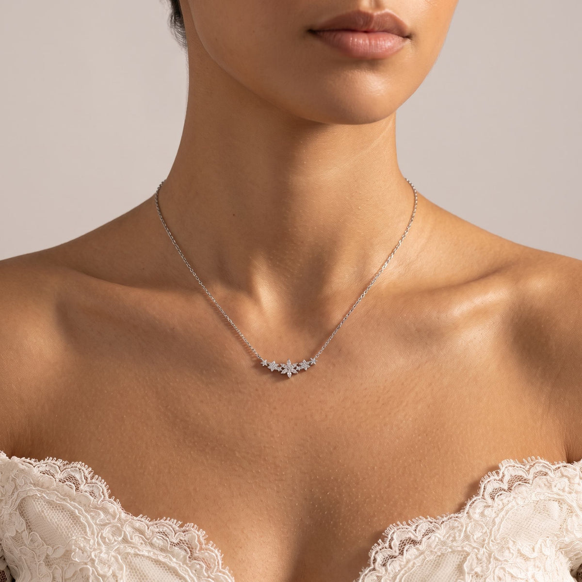 Wider view of a woman wearing the Flower Bar Necklace
