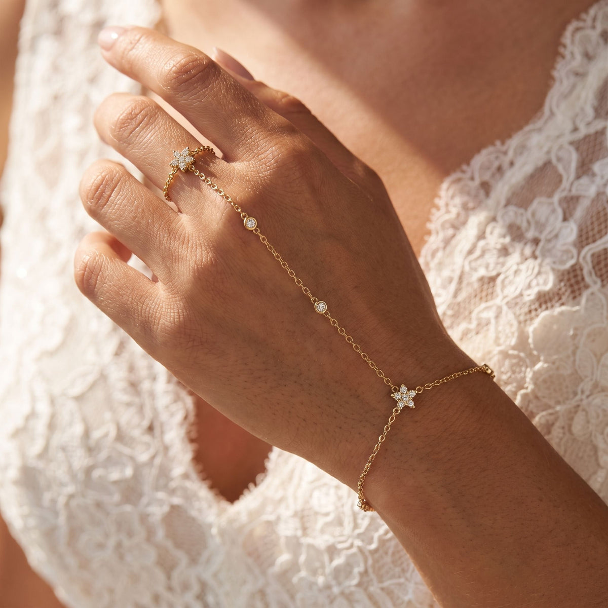 Flower Hand Chain worn across the back of the hand, with the ring on the finger and the chain at the wrist.