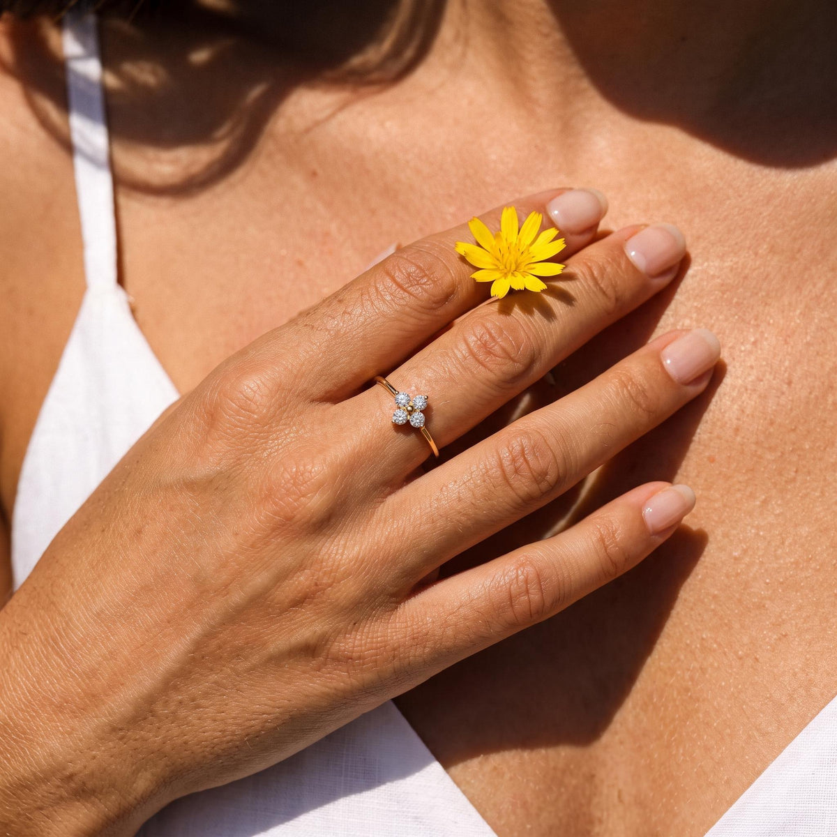 Wider view of a hand wearing the Four Petal Ring