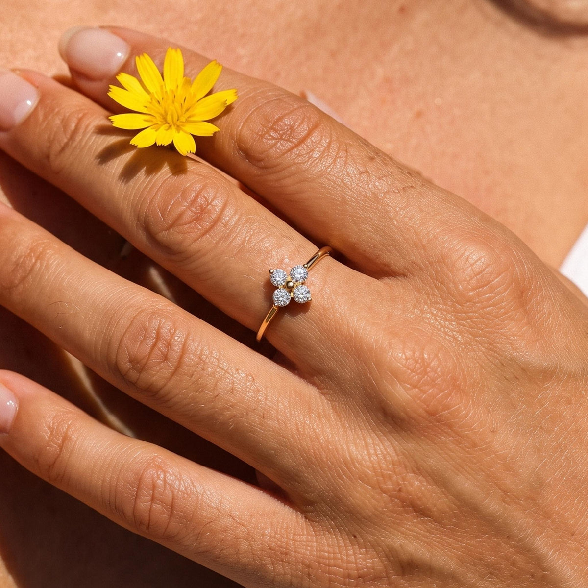Close-up of the Four Petal Ring worn on the finger