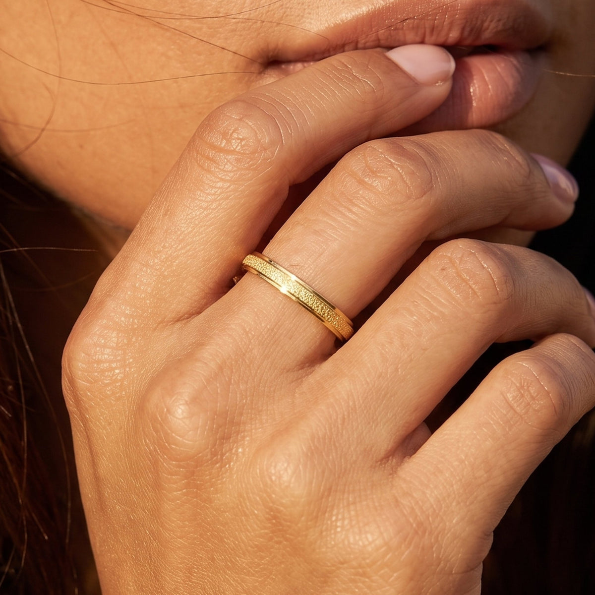 Close-up of the Frosted Gold Ring worn on the finger