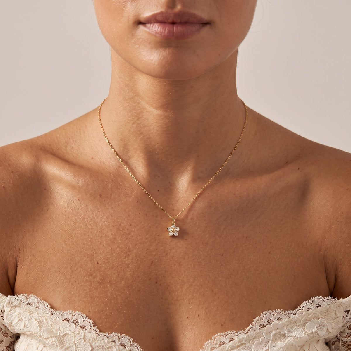 Wider view of a woman wearing the Gold Bloom Pendant