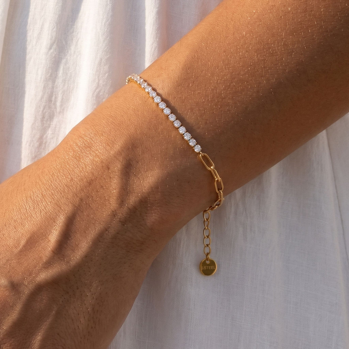 Gold Split Tennis Bracelet worn on the wrist, photographed in natural daylight.