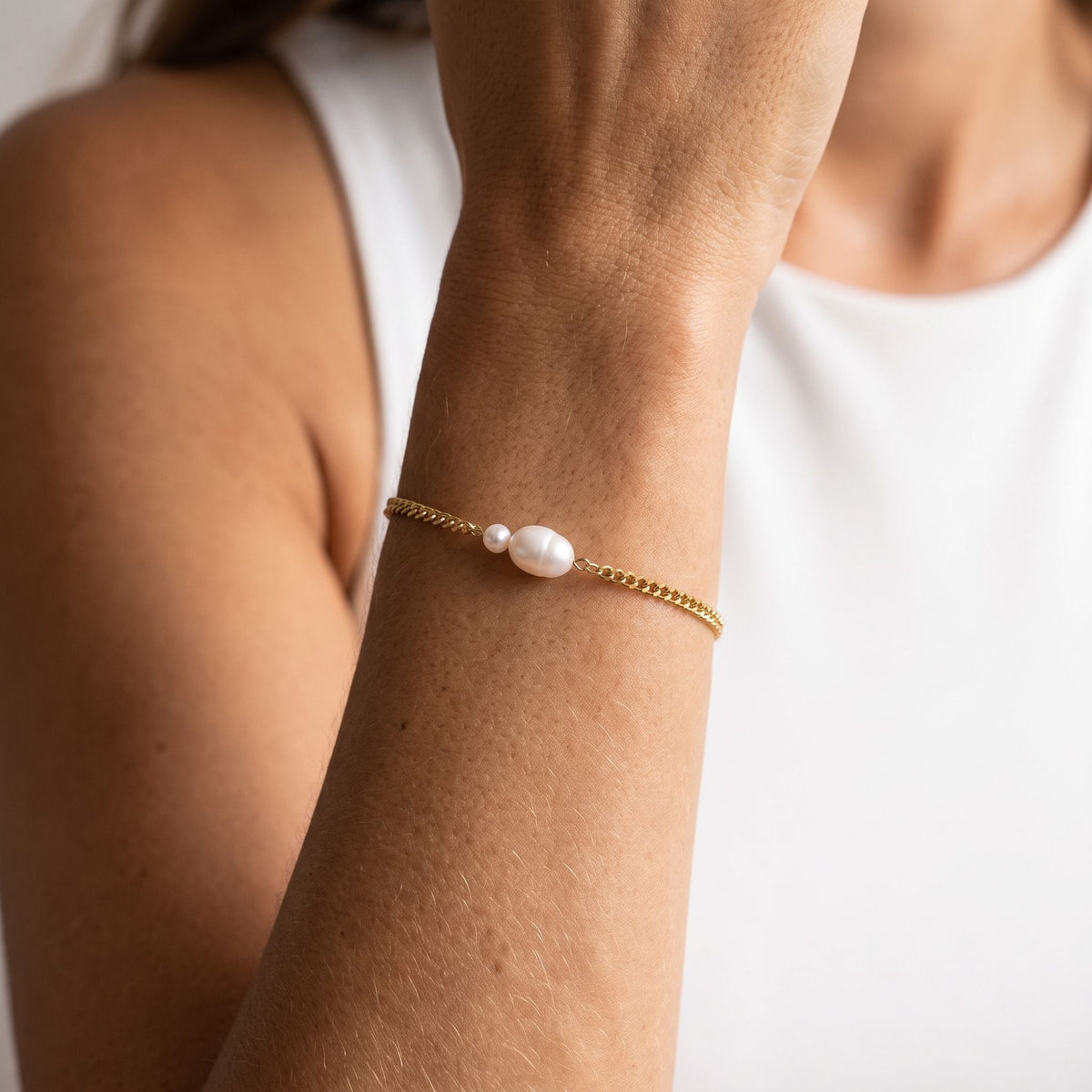 Gold Twin Pearl Bracelet worn on the wrist, photographed in natural daylight.