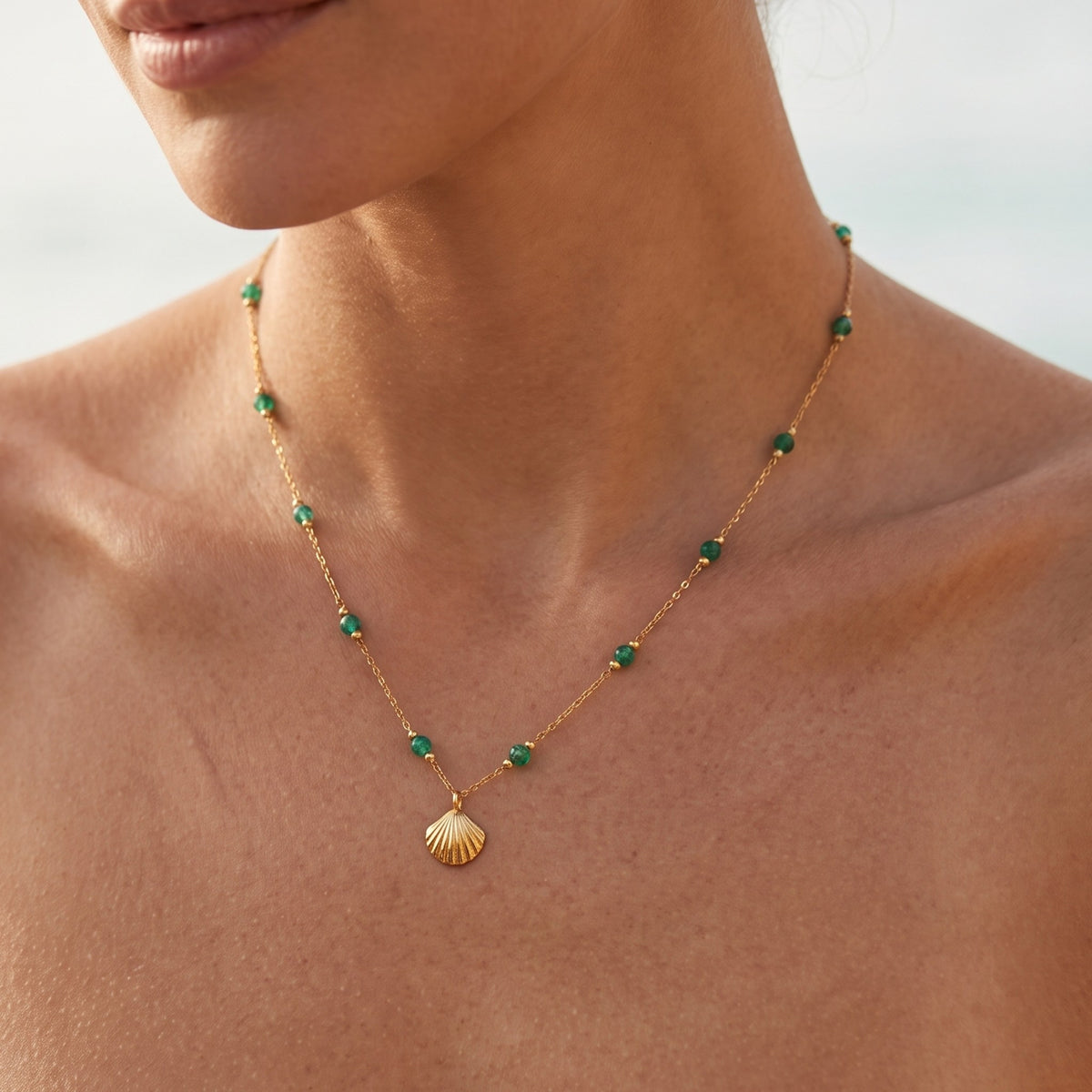 Close-up of the Green Shell Necklace worn on the neckline