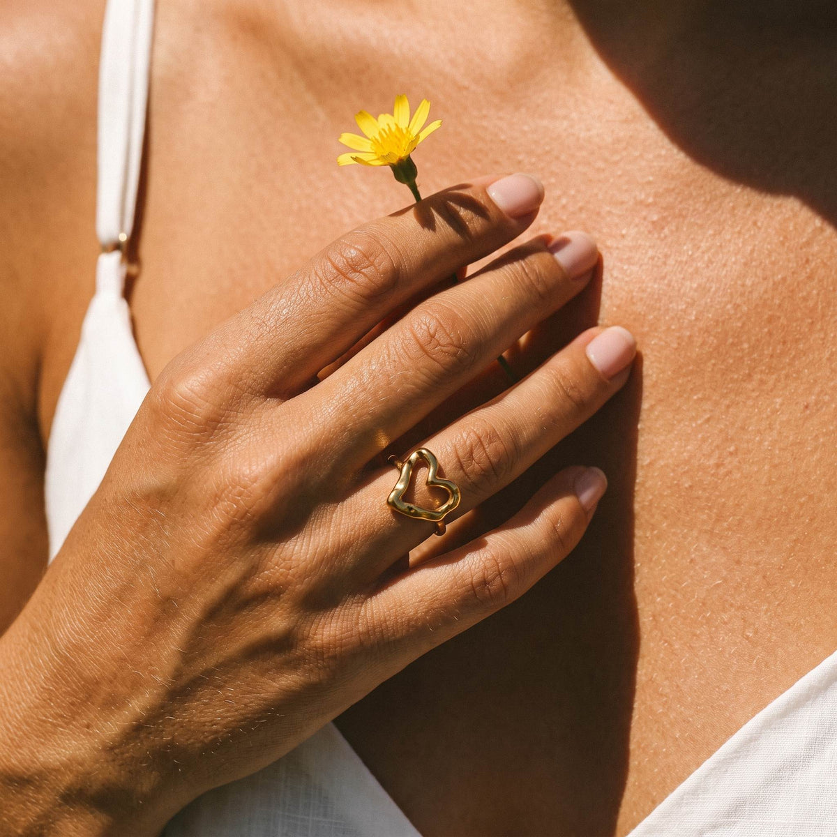 Wider view of a hand wearing the Hammered Heart Ring