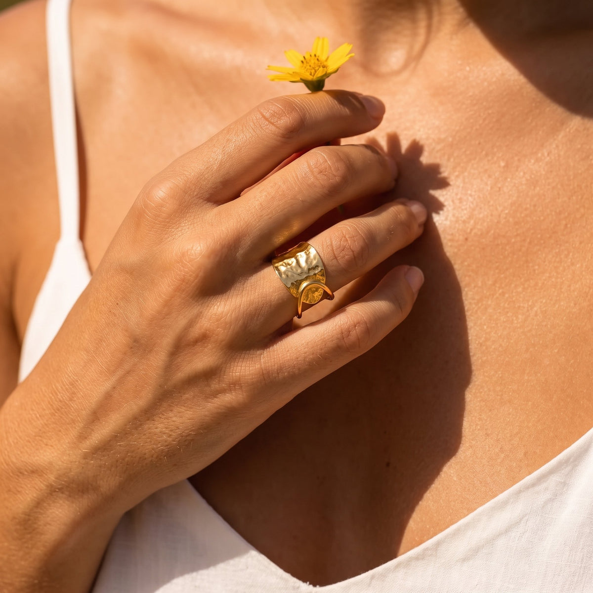 Wider view of a hand wearing the Hammered Plate Ring