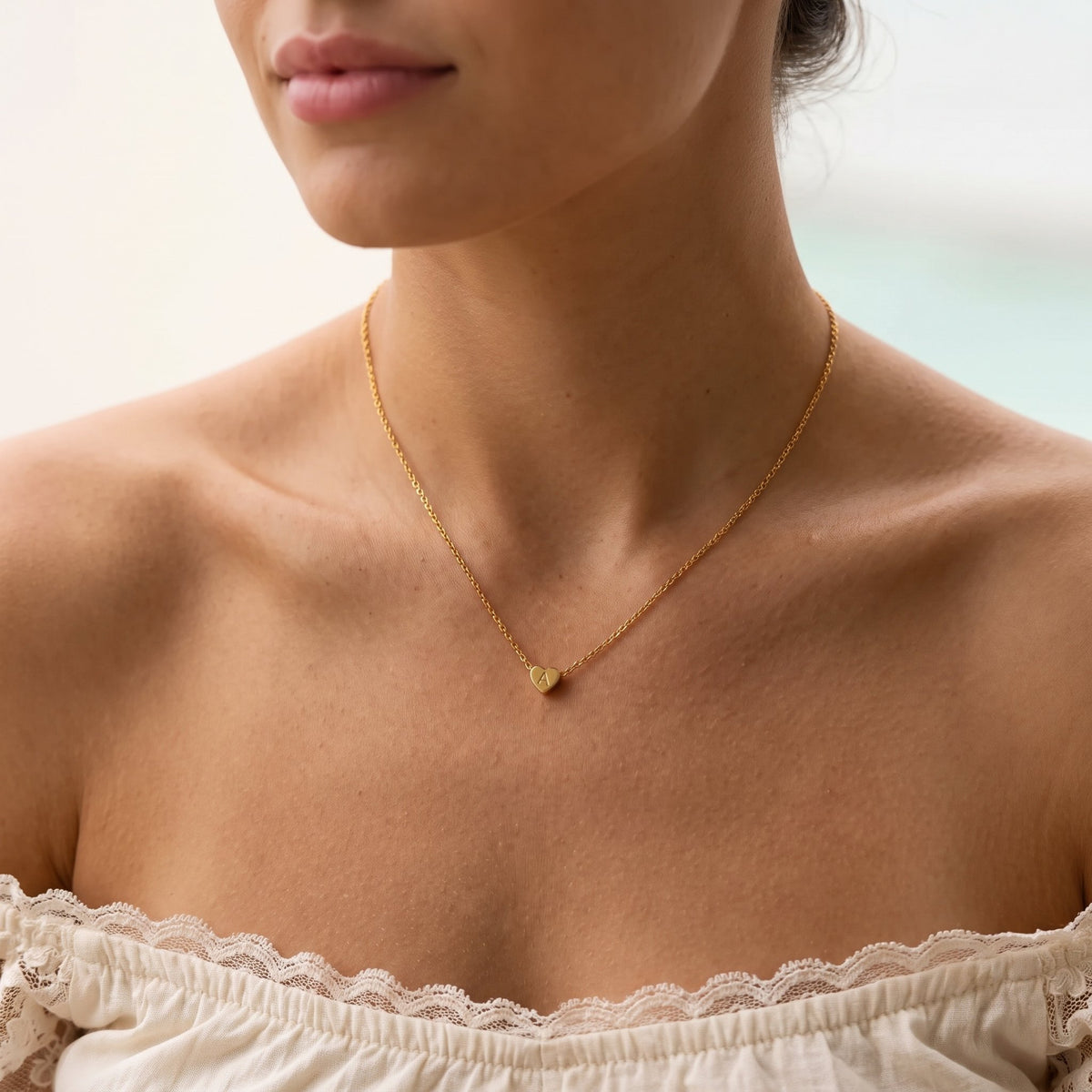 Wider view of a woman wearing the Heart Initial Necklace