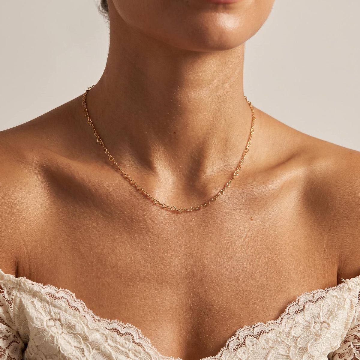 Wider view of a woman wearing the Heart Link Necklace