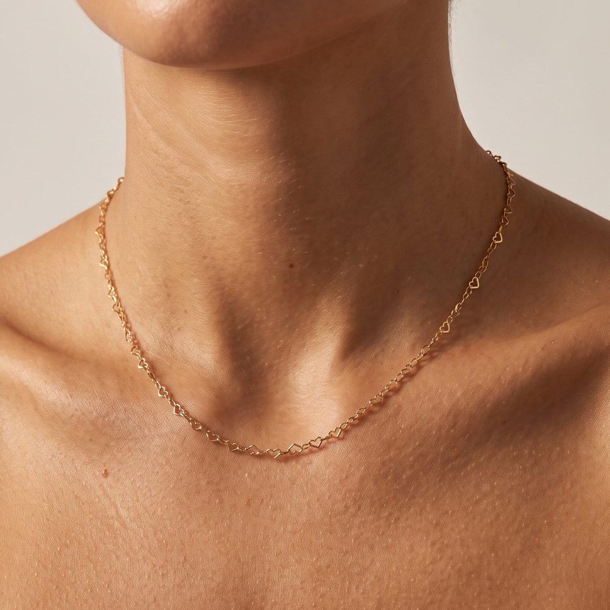 Close-up of the Heart Link Necklace worn on the neckline