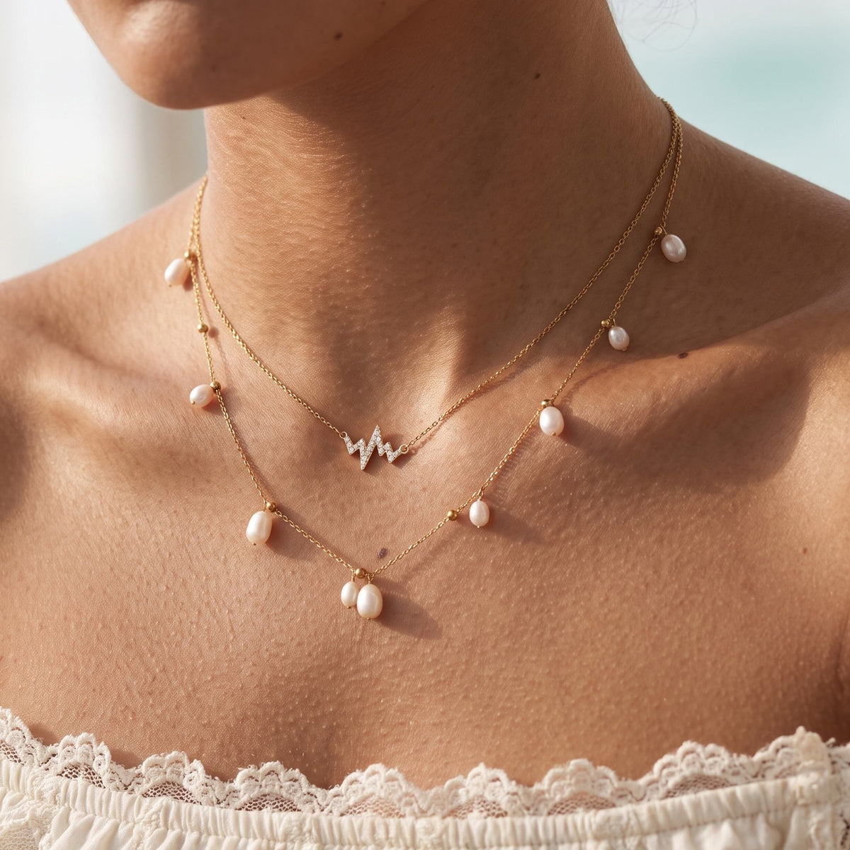 Close-up of the Heartbeat Pearl Necklace worn on the neckline