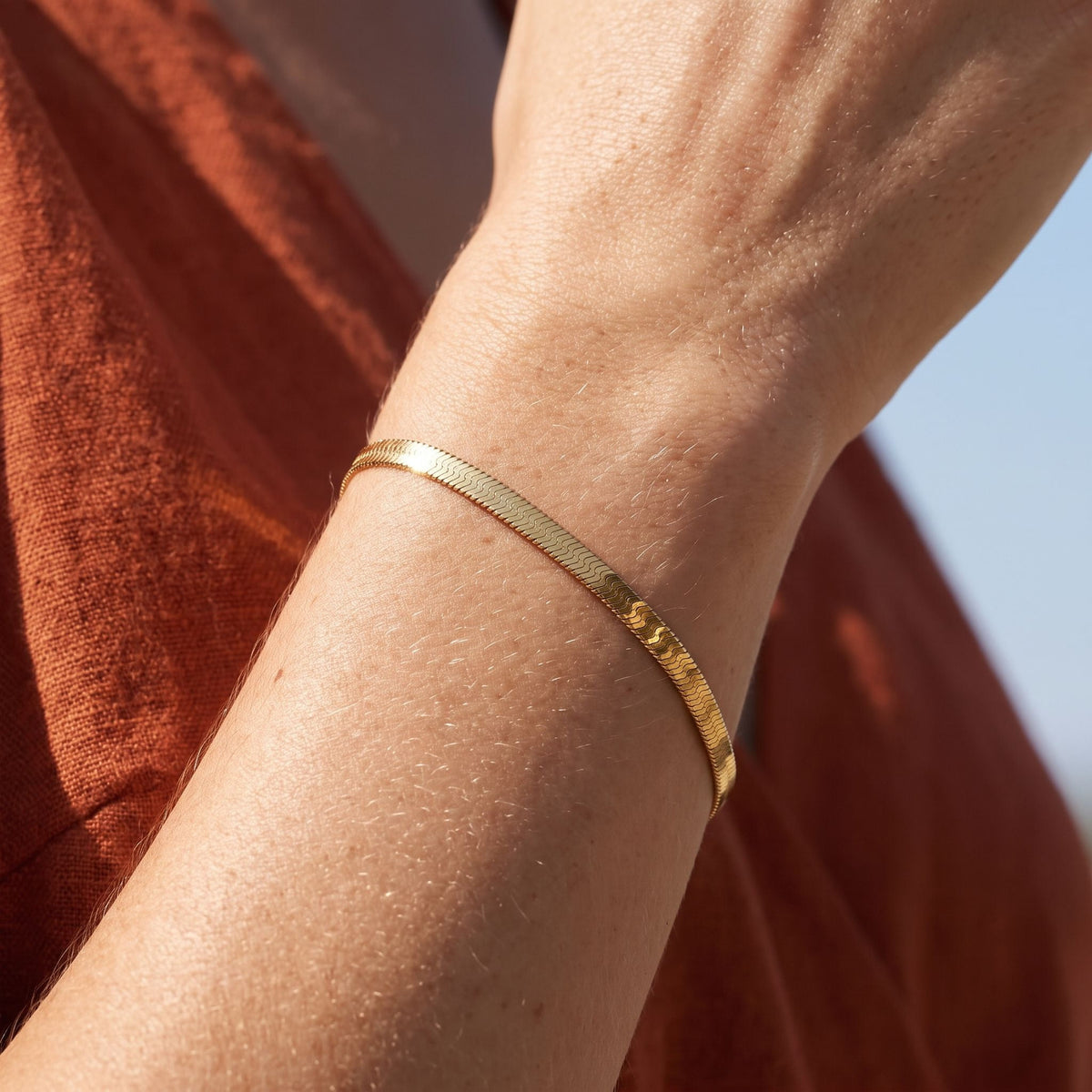 Herringbone Bracelet worn on the wrist, photographed in natural daylight.