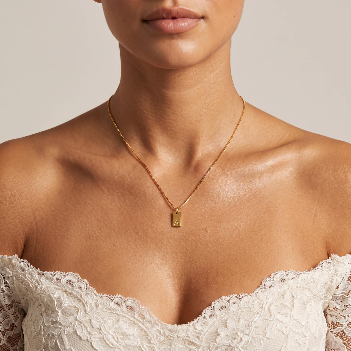 Wider view of a woman wearing the Initial Tag Necklace