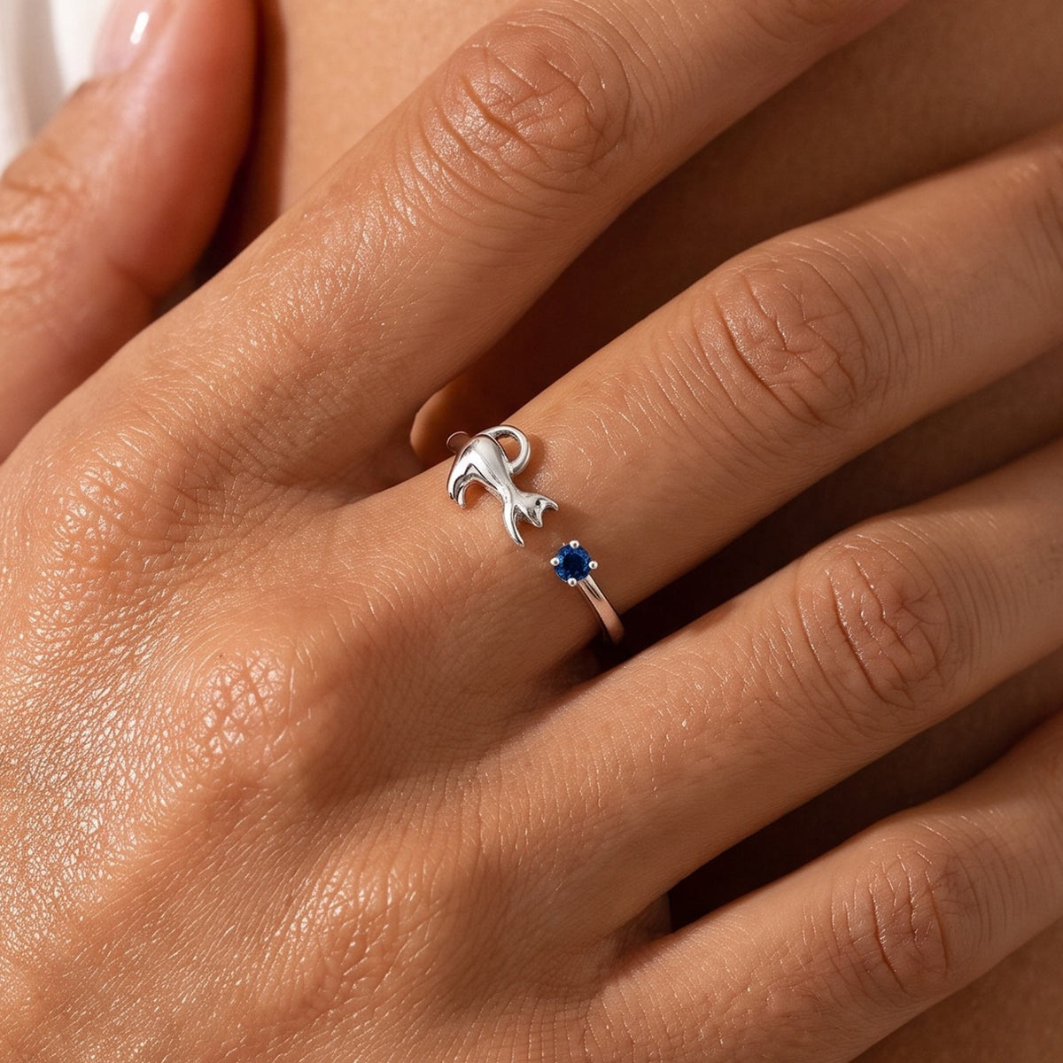 Close-up of the Kitten Ring worn on the finger