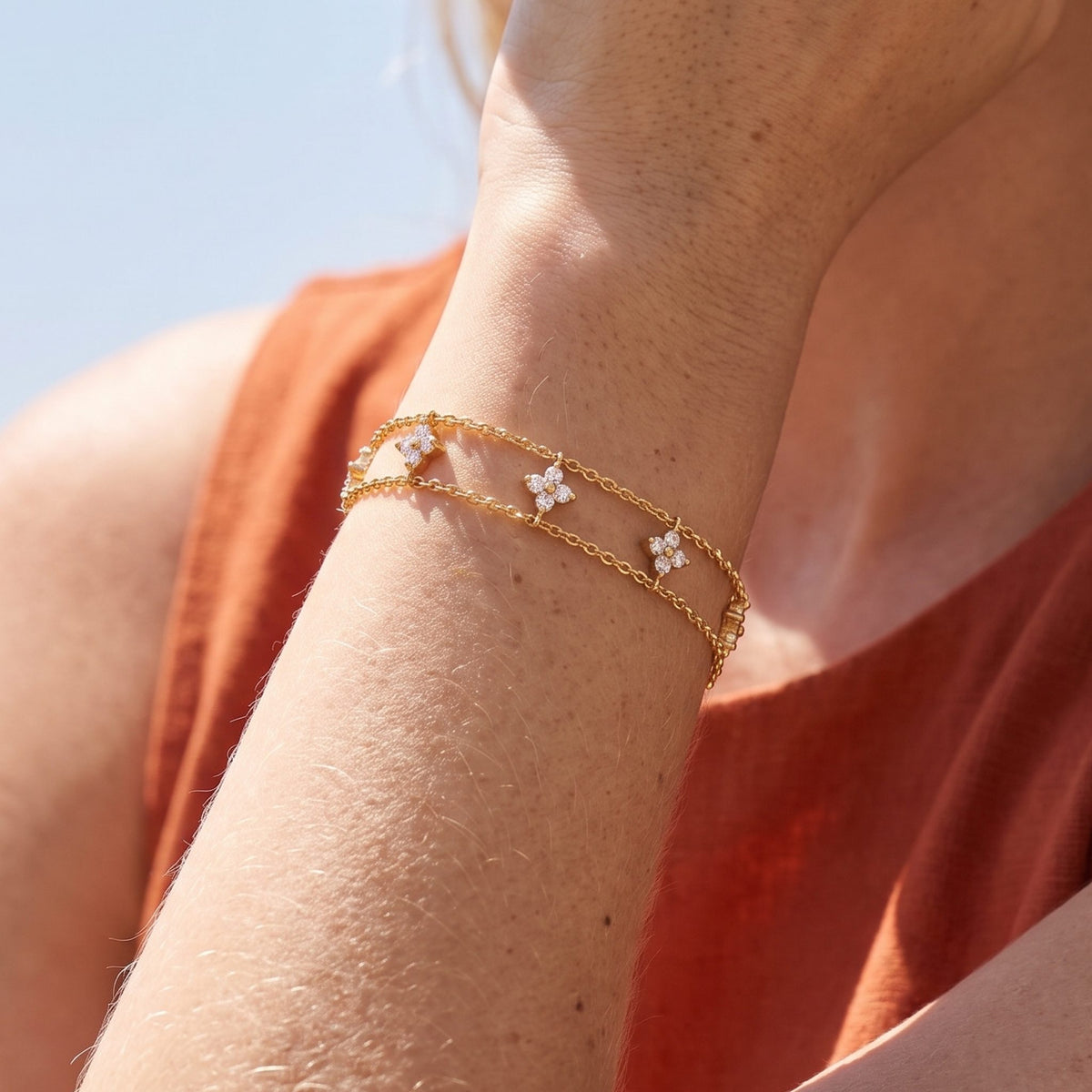 Close-up of the Layered Clover Bracelet on the wrist, highlighting its sparkling crystal clover charms