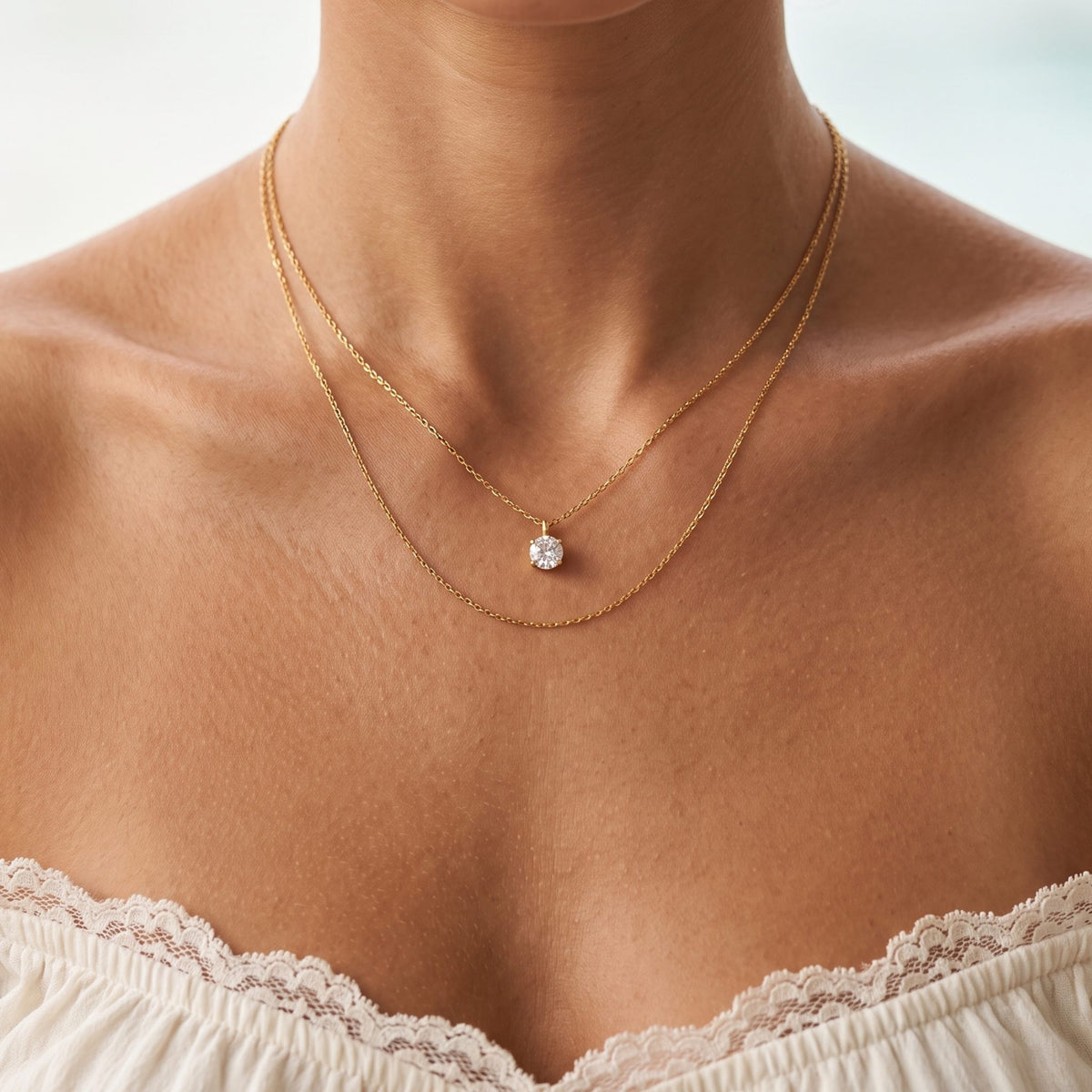 Close-up of the Layered Solitaire Necklace worn on the neckline