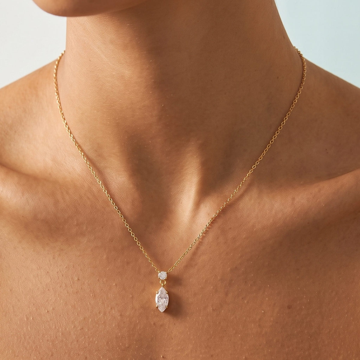 Close-up of the Marquise Drop Pendant at the collarbone, highlighting its sparkling marquise crystal drop