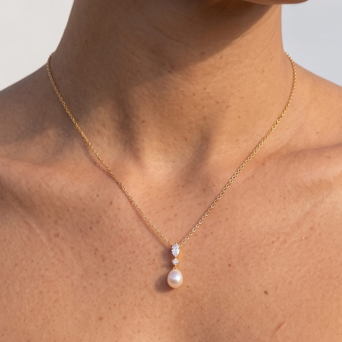 Close-up of the Marquise Pearl Pendant at the collarbone, highlighting its marquise crystal and pearl drop