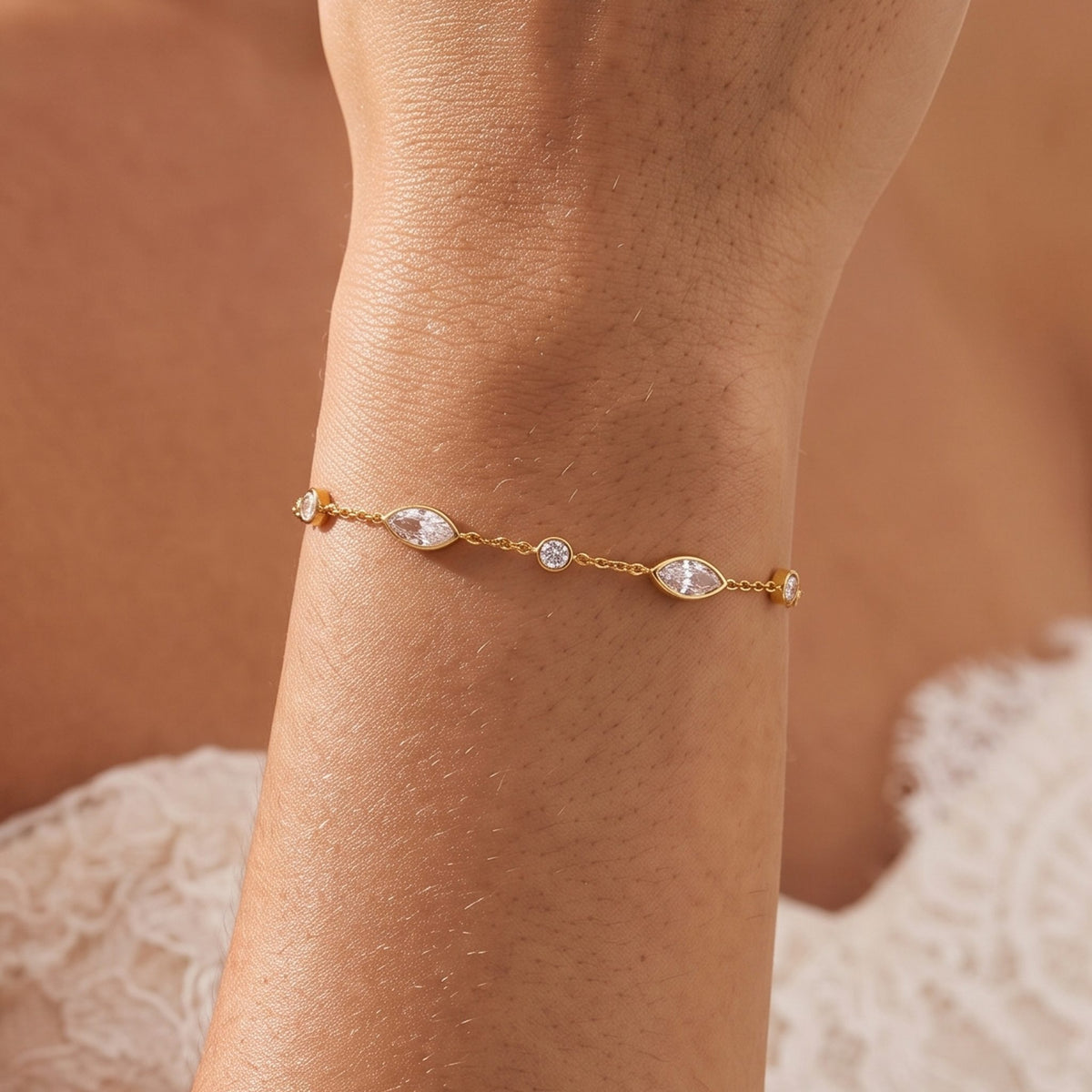 Close-up of the Marquise Station Bracelet on the wrist, showing its gold chain and sparkling crystals