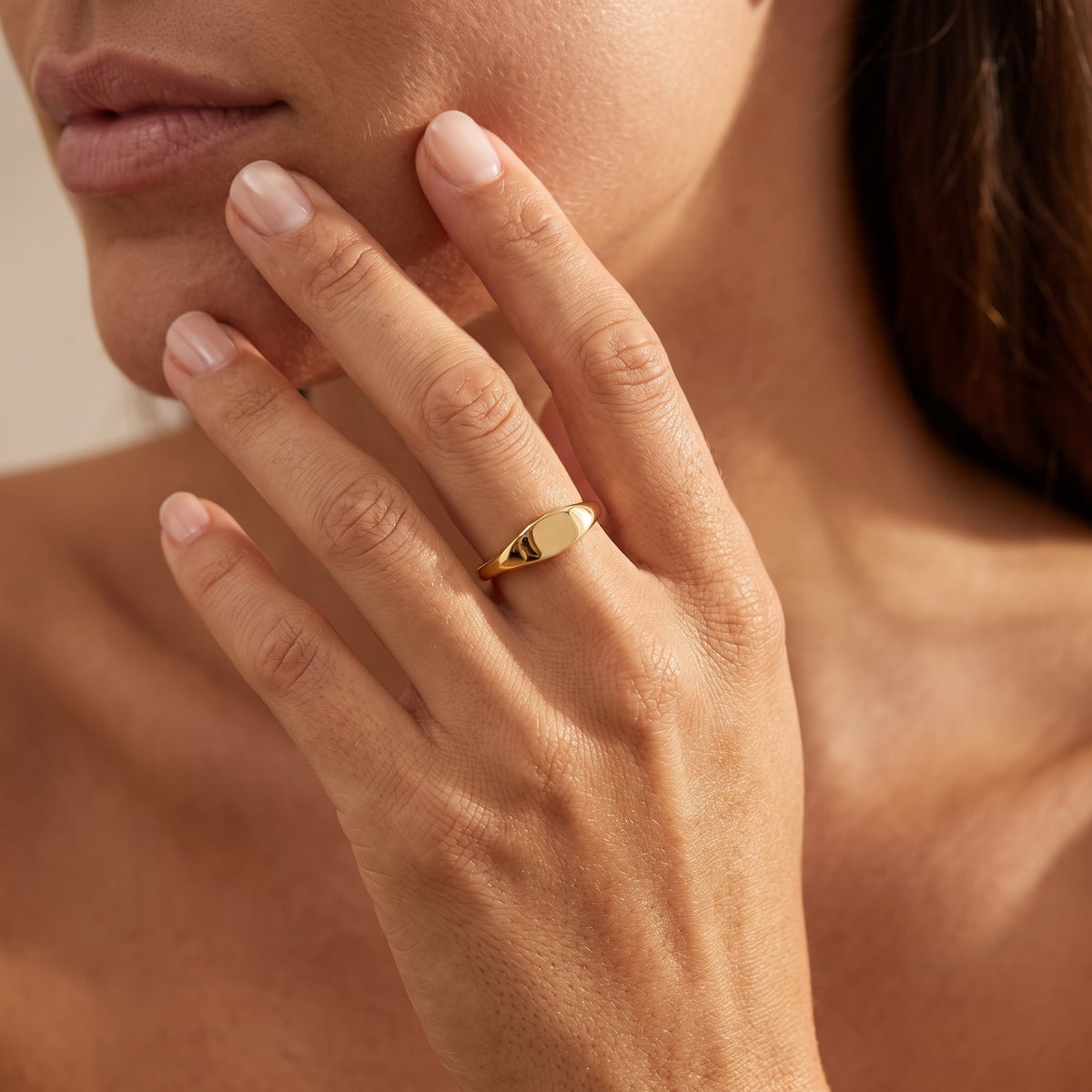 Wider view of a hand wearing the Mini Signet Ring
