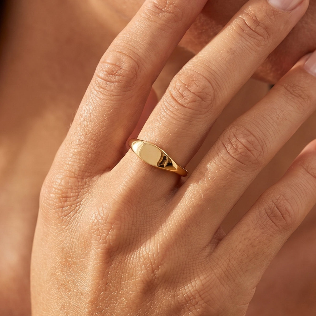 Close-up of the Mini Signet Ring worn on the finger