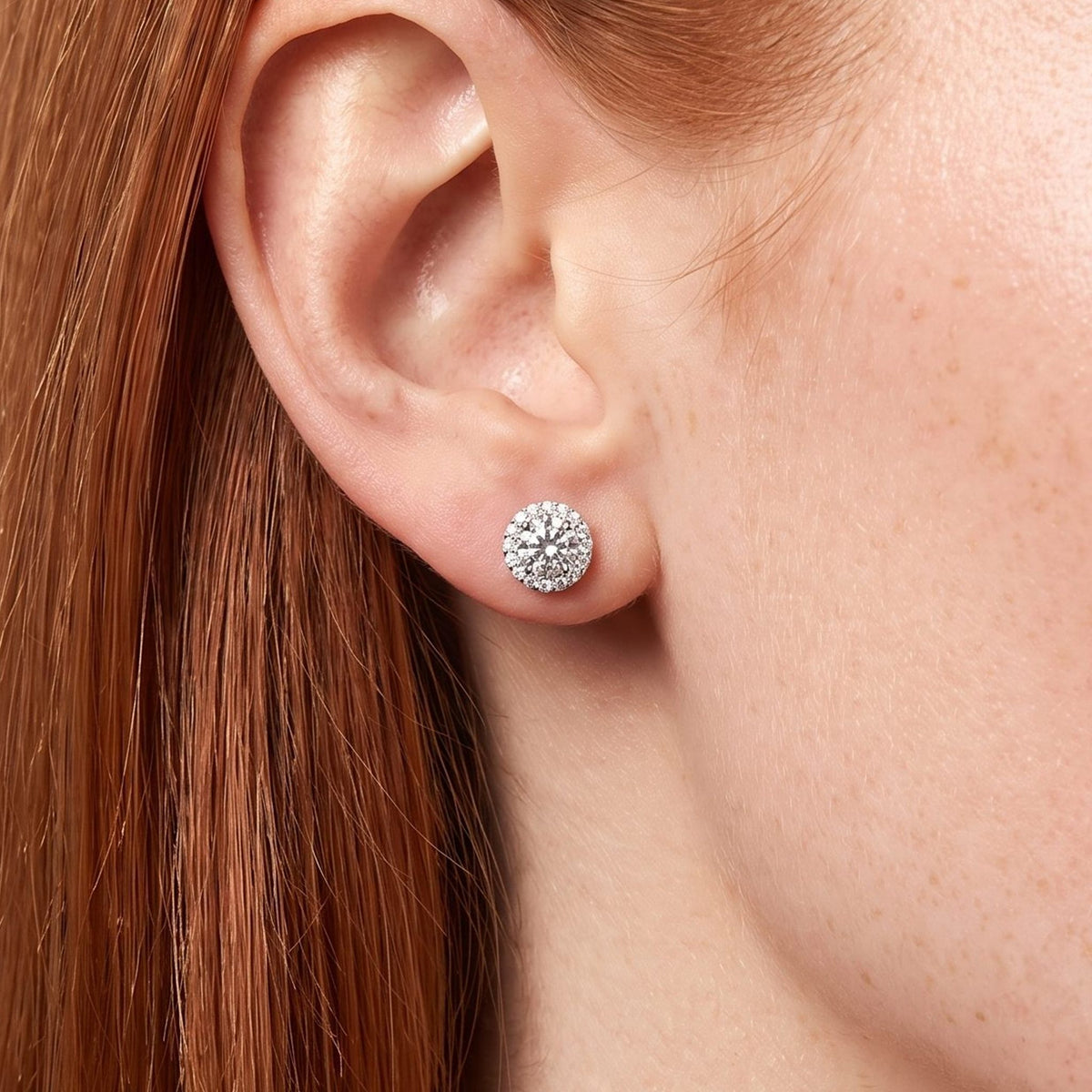 Woman wearing the Olivia Cercle Halo Earrings on the lobe with a silver-colored setting