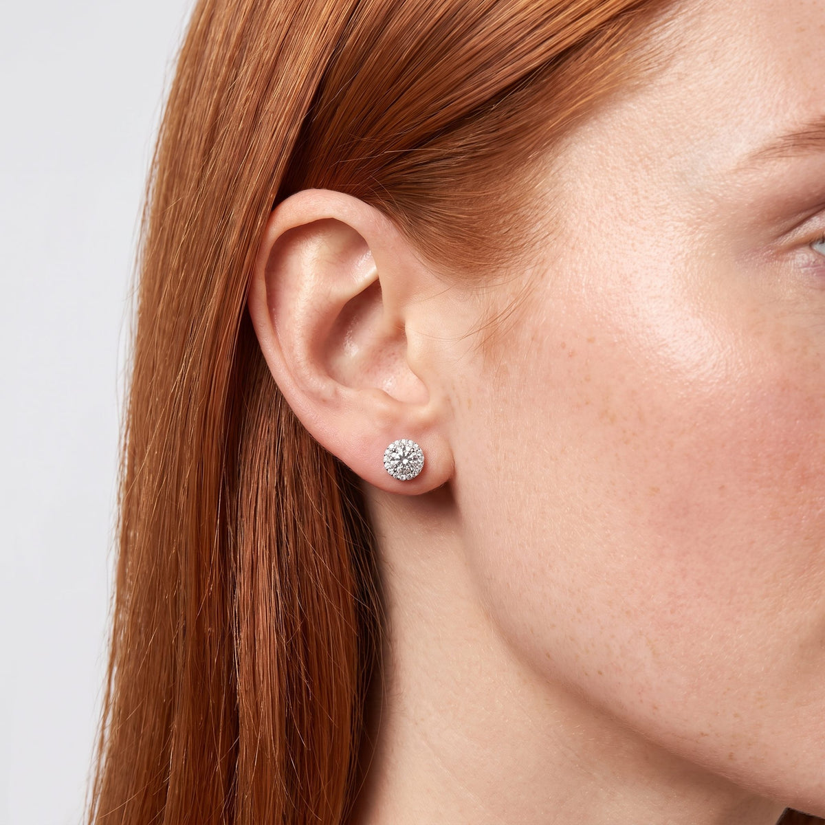 Woman wearing the Olivia Cercle Halo Earrings on the lobe with a silver-colored setting