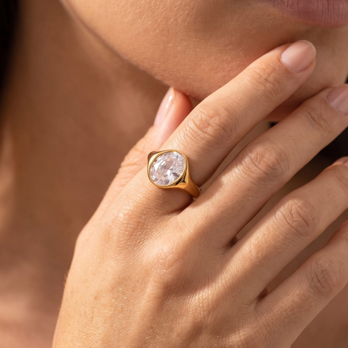 Close-up of the Oval Signet Ring on the ring finger, featuring a large oval crystal