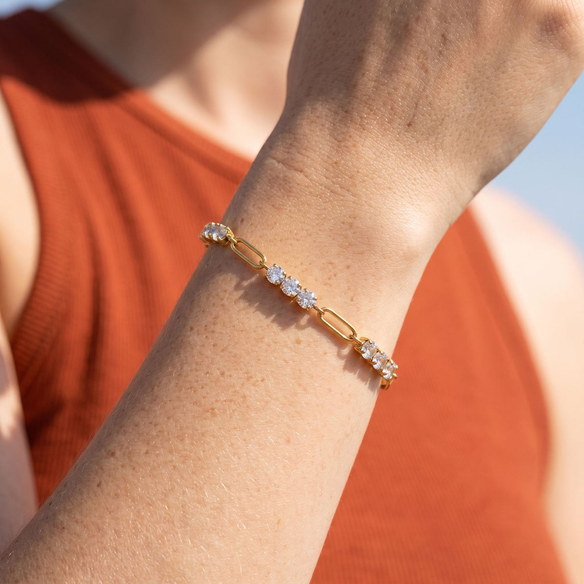 Paperclip Tennis Bracelet worn on the wrist, photographed in natural daylight.