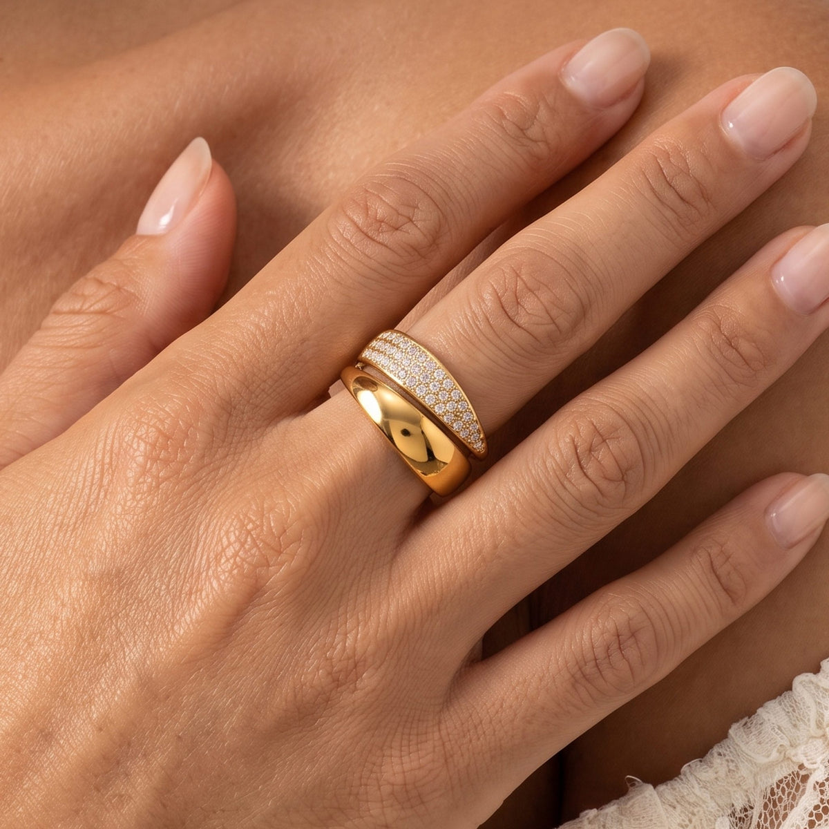 Close-up of the Pavé Bypass Ring on a ring finger, highlighting its shimmering crystals and smooth gold band