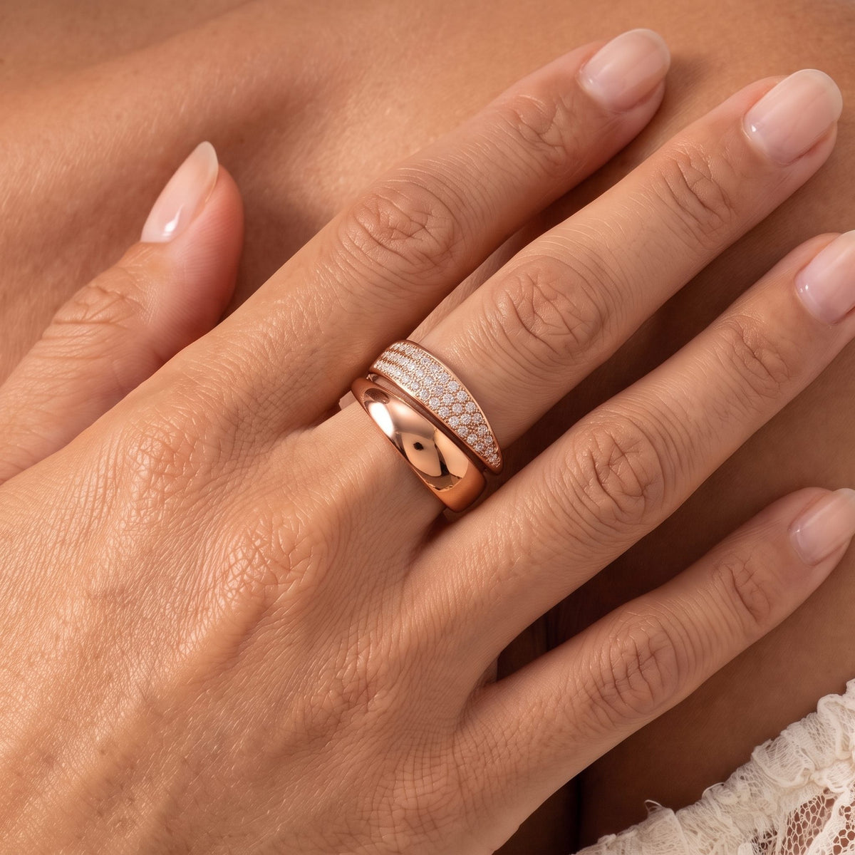 Close-up of the Pavé Bypass Ring on a ring finger, highlighting its shimmering crystals and smooth rose gold band