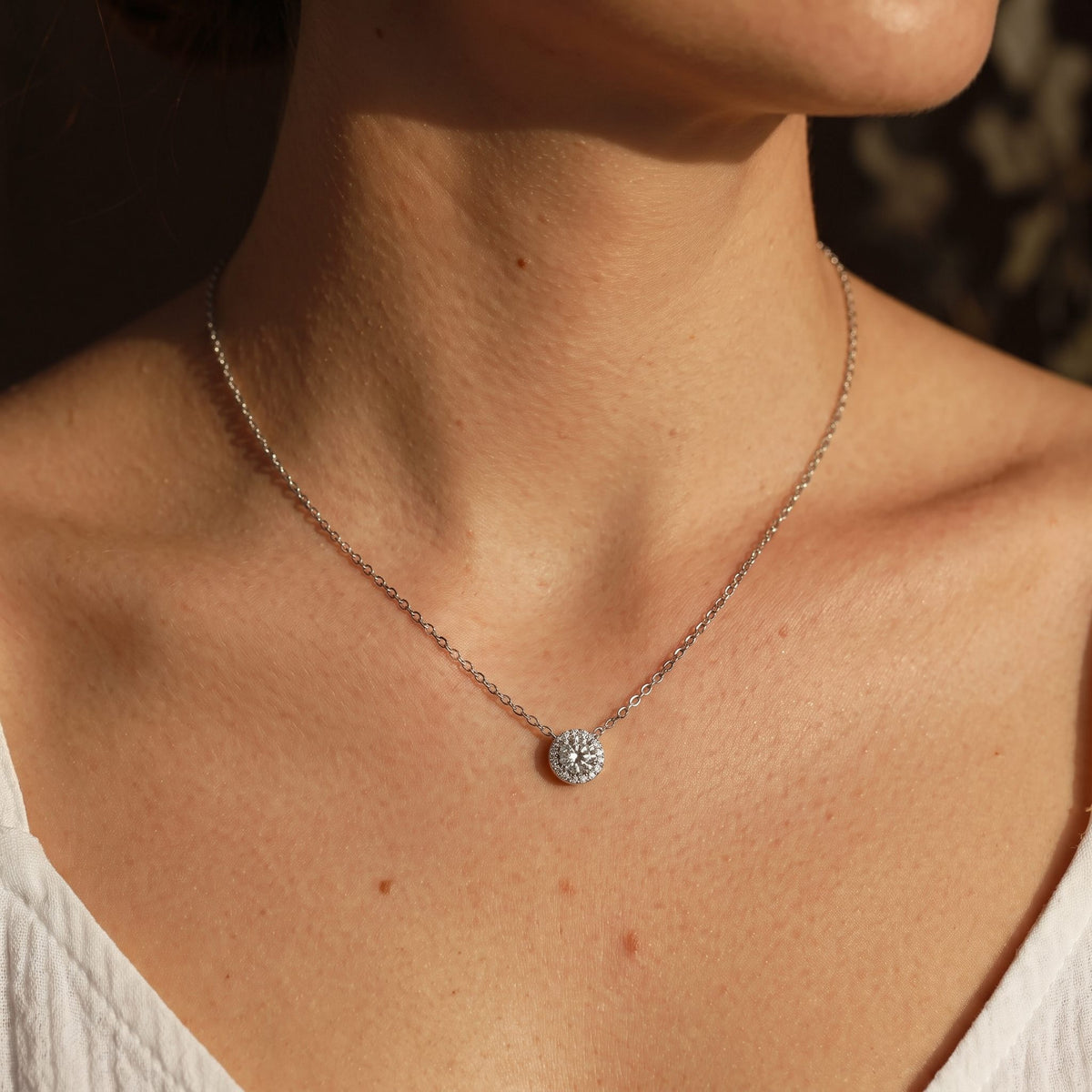 Woman wearing the Pavé Disc Pendant on the neckline