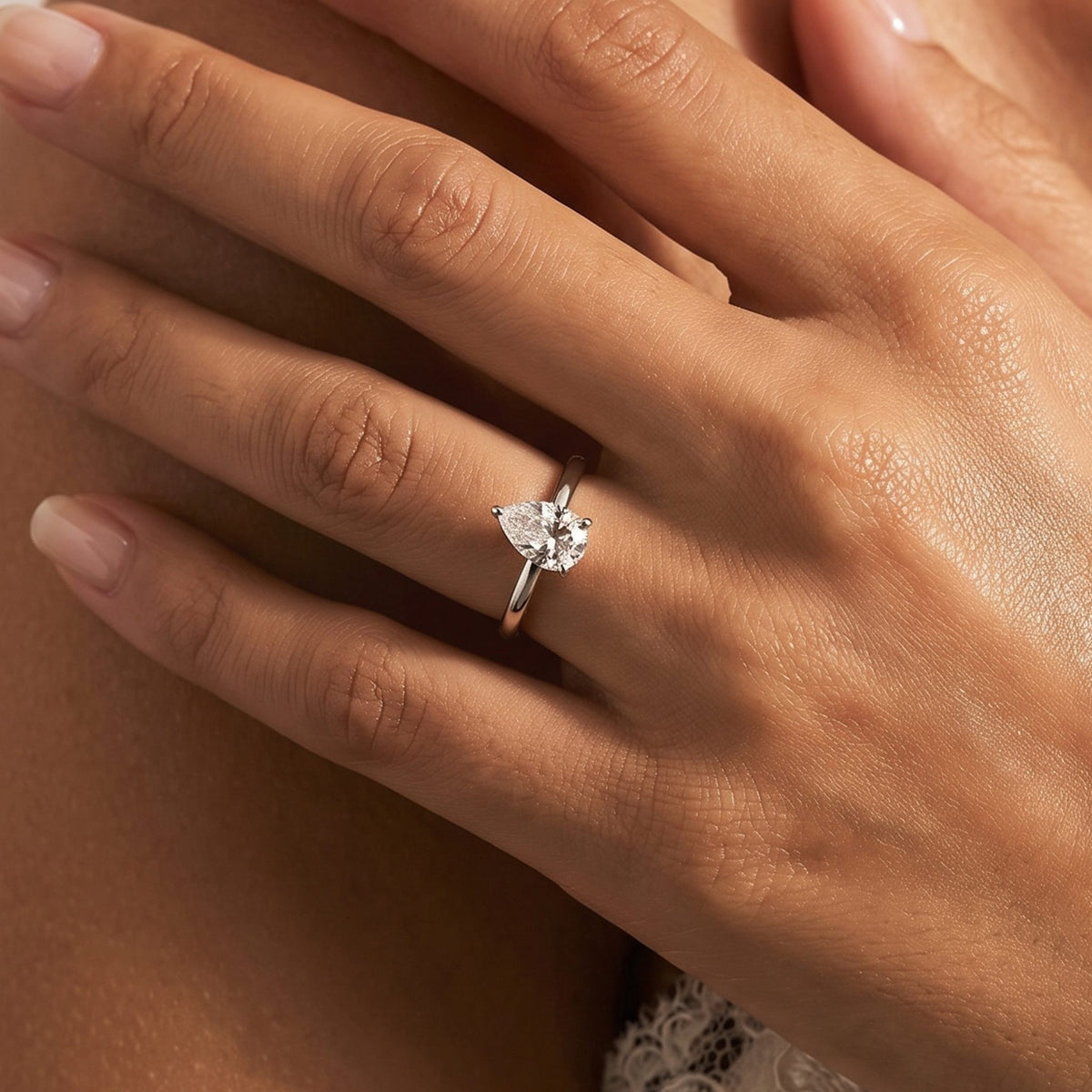 Close-up of the Pear Solitaire Ring worn on the finger